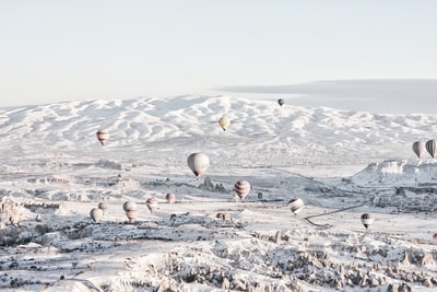 白昼雪地下各色气球